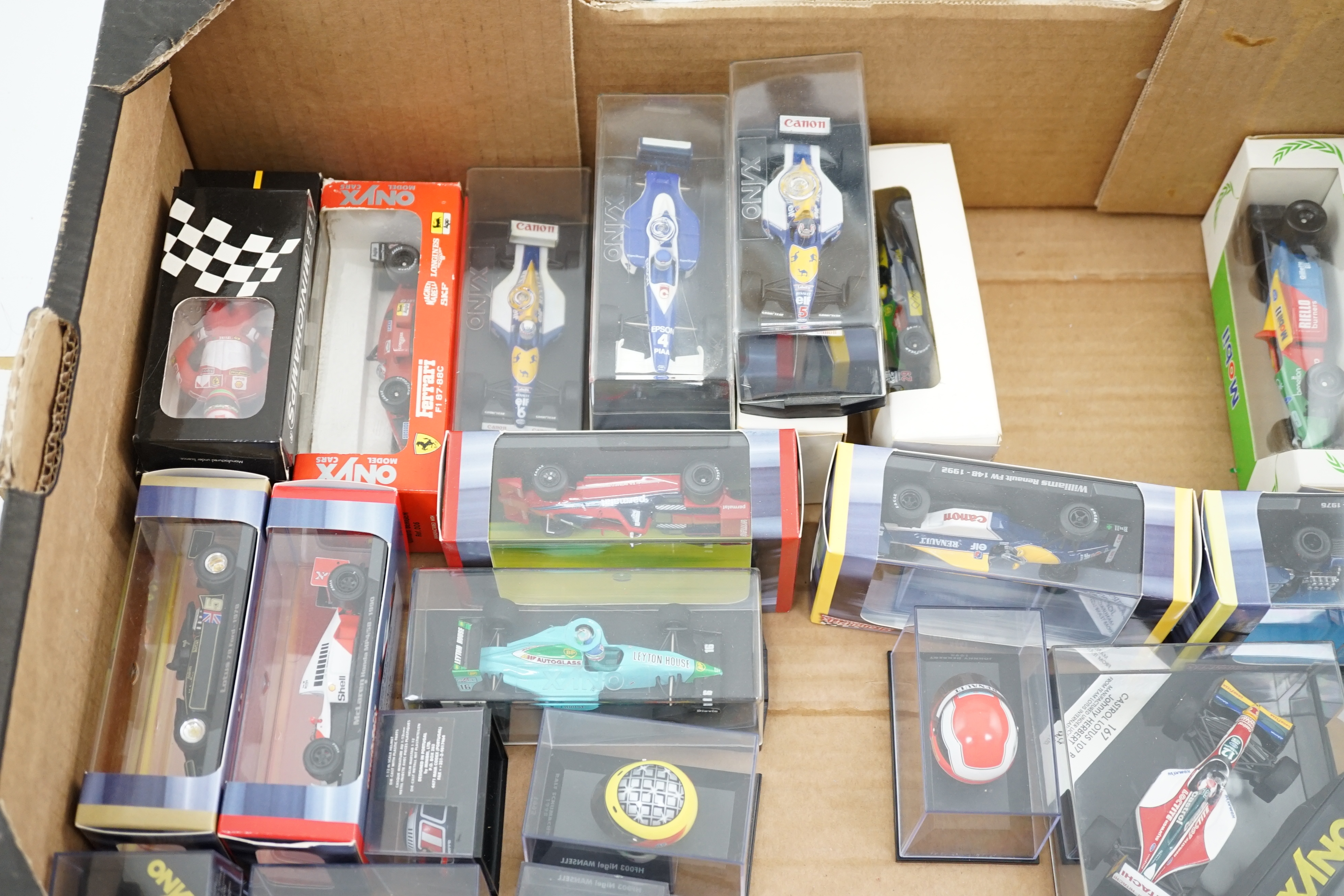 Thirty-seven boxed diecast motor racing related models by Onyx, Atlas Editions, etc. including 1:43 scale Formula One racing cars, models of helmets of famous drivers, etc.